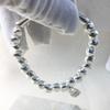 Bracciale Uno de 50 con Chiusura a Moschettone con Perla Irregolare d'Argento - Design Geometrico