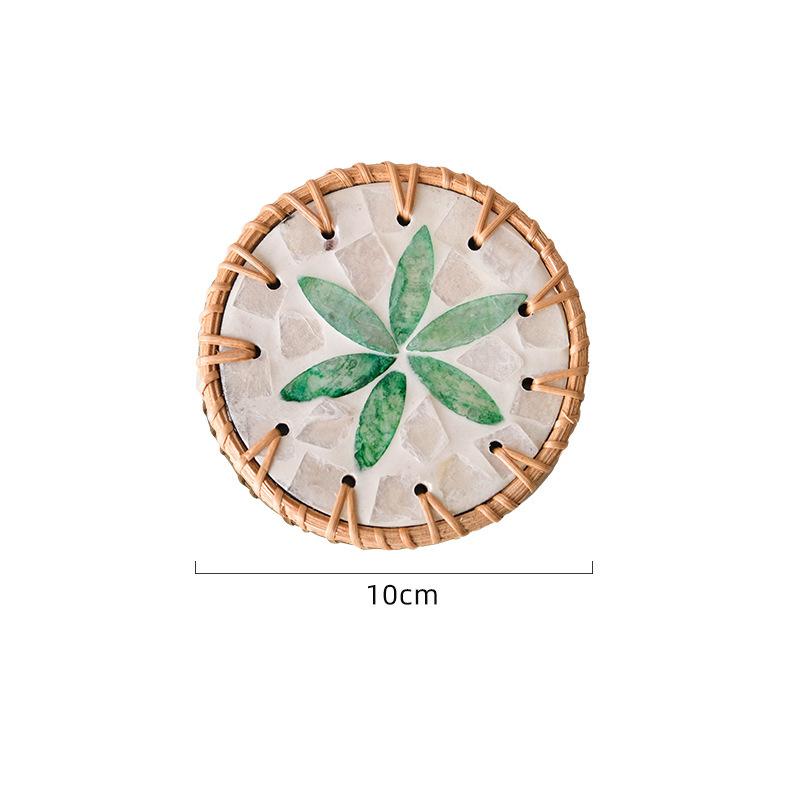 The hand - made rattan - edged shell coasters add a unique marine style to the tabletop.
