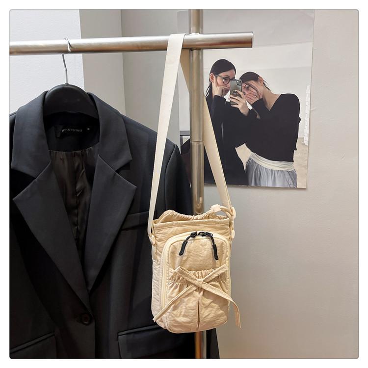 

Korean version messenger bag women 2025 new simple bow bucket bag casual out mobile phone bag versatile water cup bag хакі