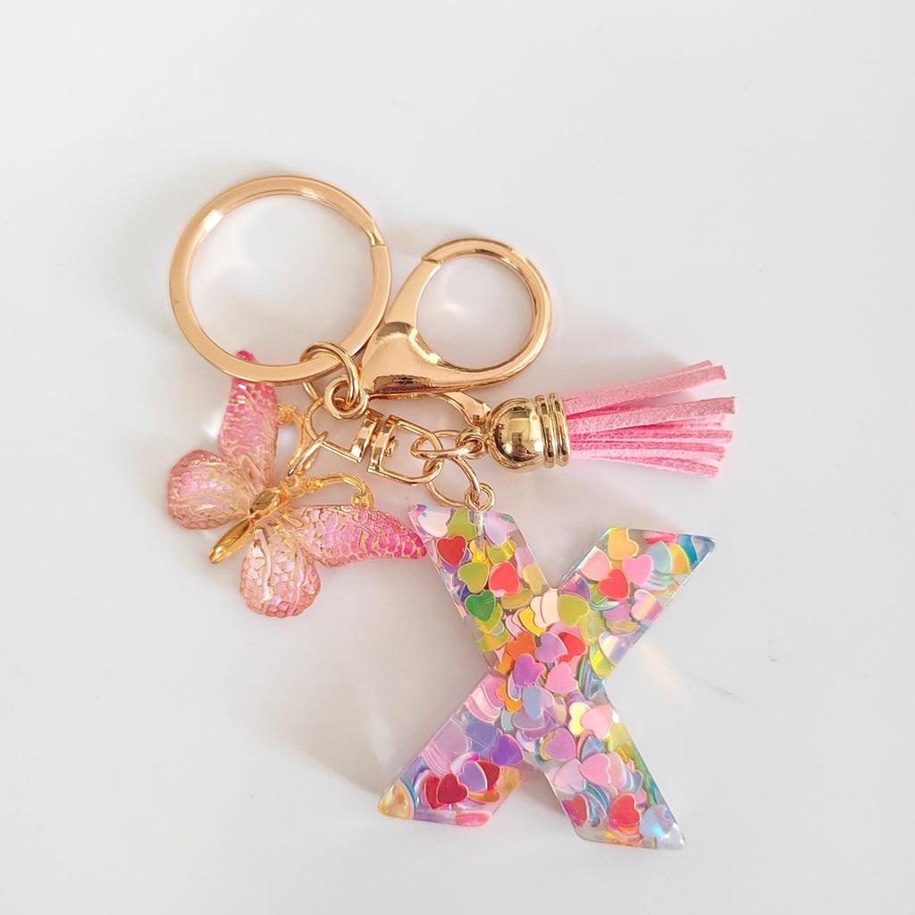 Rosa Glitzer Epoxidharz Schlüsselanhänger mit englischem Buchstaben und Schmetterlingsquaste