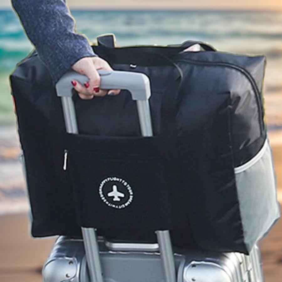 Compact travel bag: suitcase-compatible, hand-held, features an external pocket, handle slip-over design, with matching accessory bag.