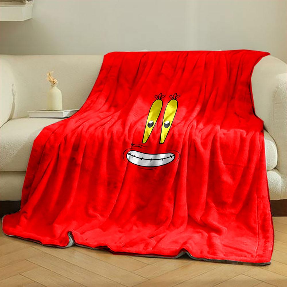 A cartoonish smiling face with big yellow eyes on a red background. for all seasons blanket lunch break throw gift