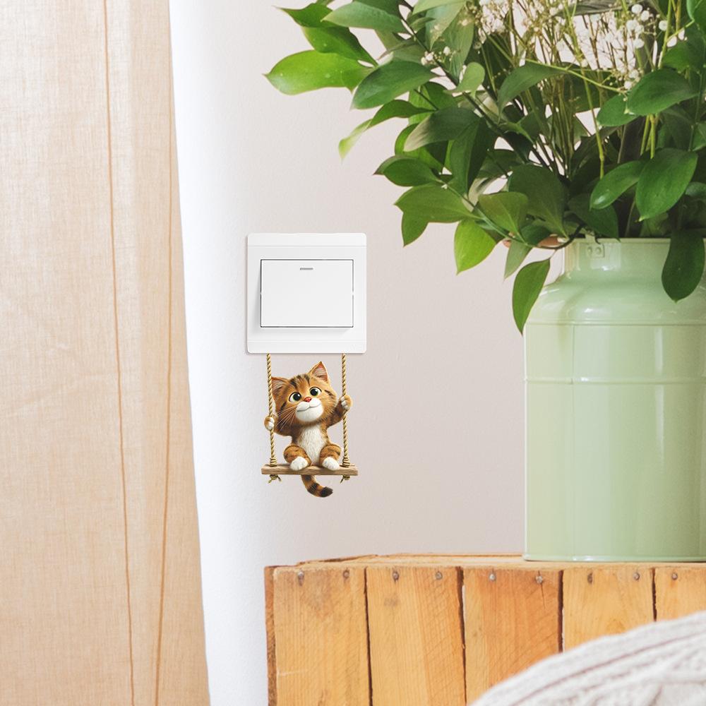 Süße kleine Katze schwingt auf der Schaukel Hauswand Schalter Verschönerungsaufkleber