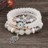 Bohemian Multi-layer Beaded Bracelet with Cross, Evil Eye, Palm Pendants, and Crystals.