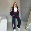 Moda casual europeo e americano completo da donna a maniche lunghe a righe colore a contrasto cerniera cardigan pantaloni allacciati set da due pezzi