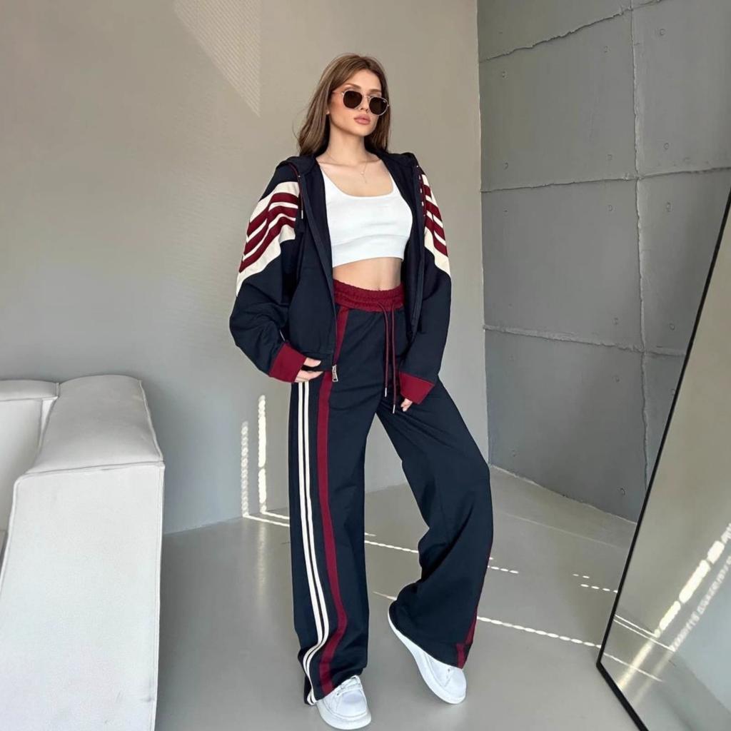 Moda casual europeo e americano completo da donna a maniche lunghe a righe colore a contrasto cerniera cardigan pantaloni allacciati set da due pezzi