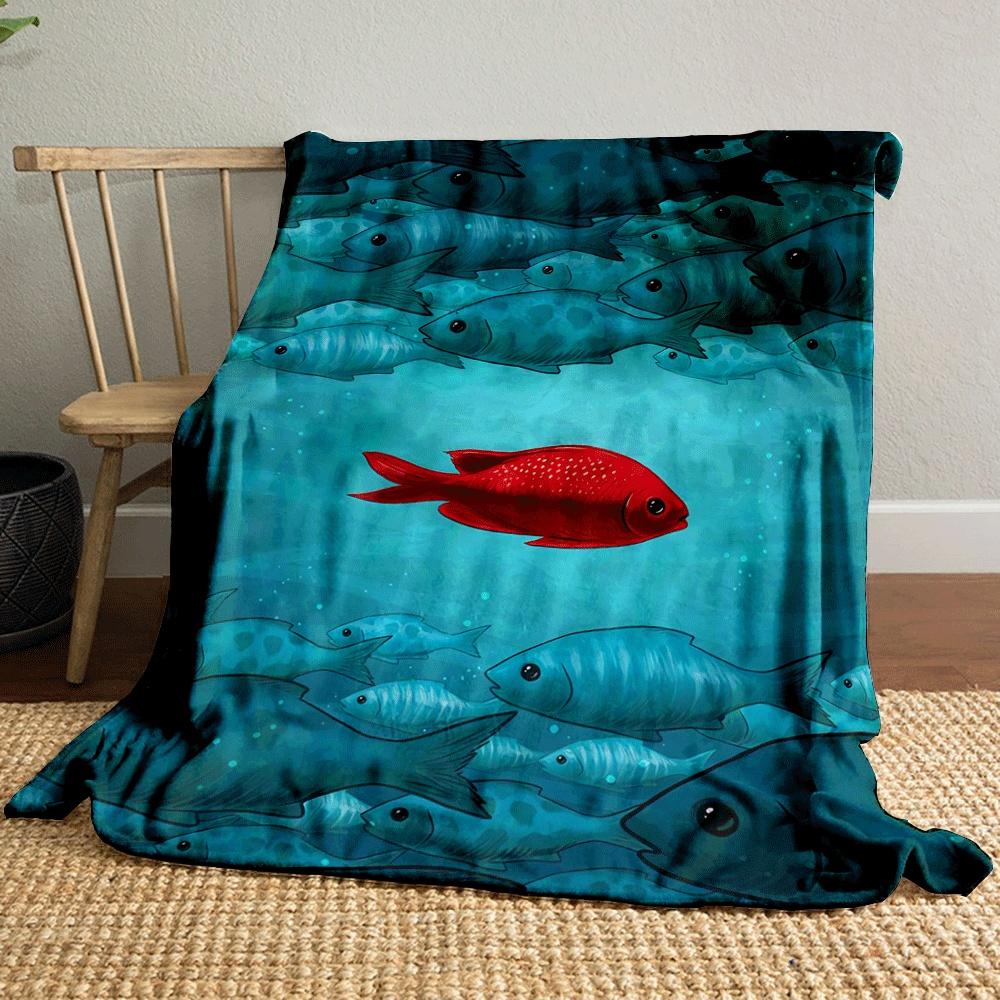 A single red fish contrasts against a large group of blue-green fishes. for all seasons blanket lunch break throw gift