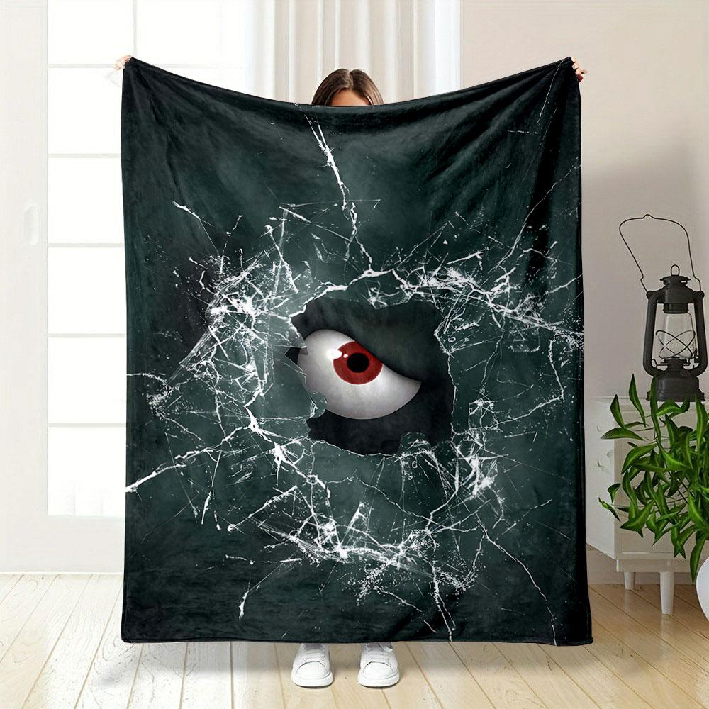 A red eye peers through shattered glass with chaotic crack patterns. for all seasons blanket lunch break throw gift