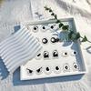 Roll of 500 Small Emoticon Wavy Eyes Stickers for Journaling, Decoration, and Envelope Sealing.