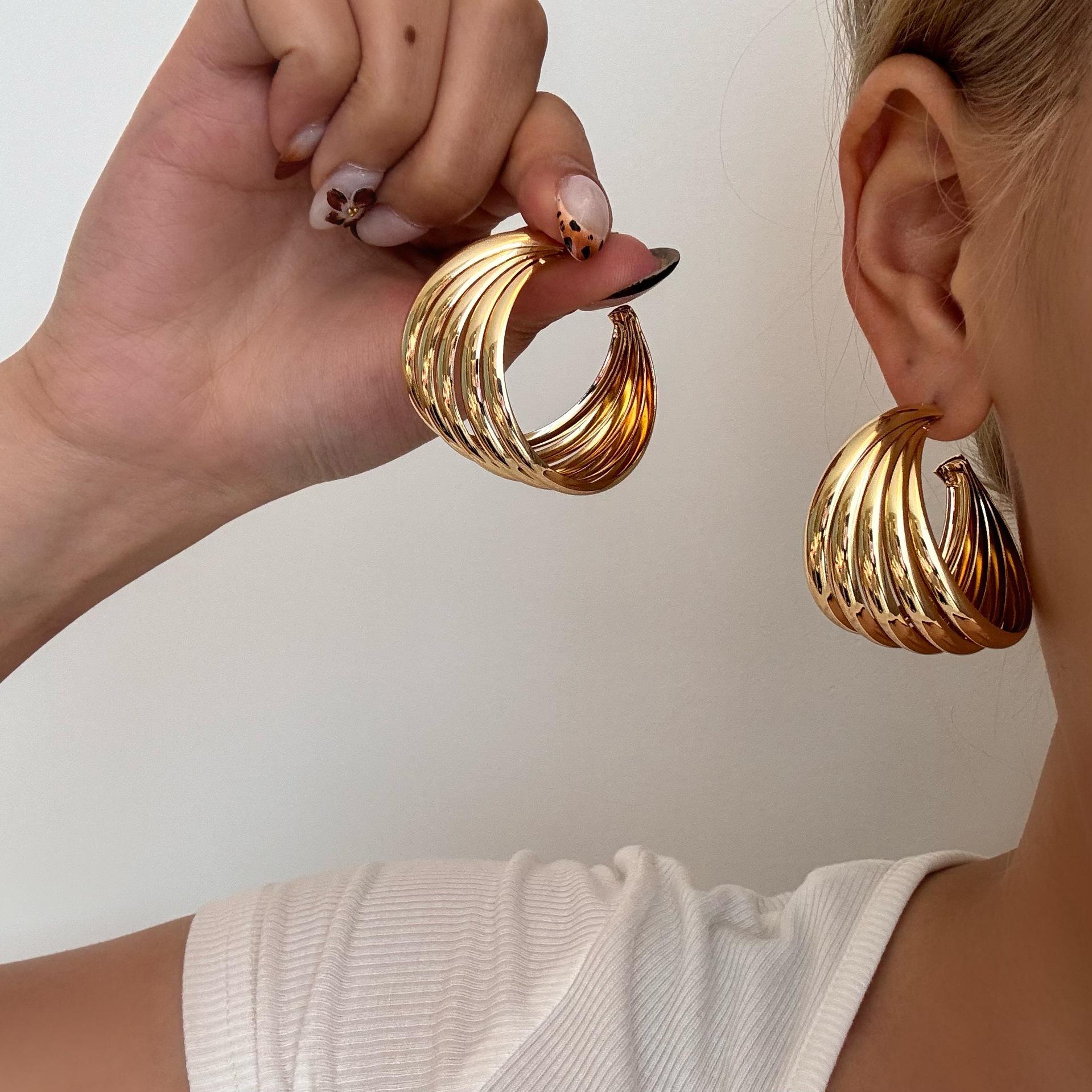 

European & American Retro Metal Twisted Hoop Earrings for Women - Bold, Versatile, and Stylish Accessory.