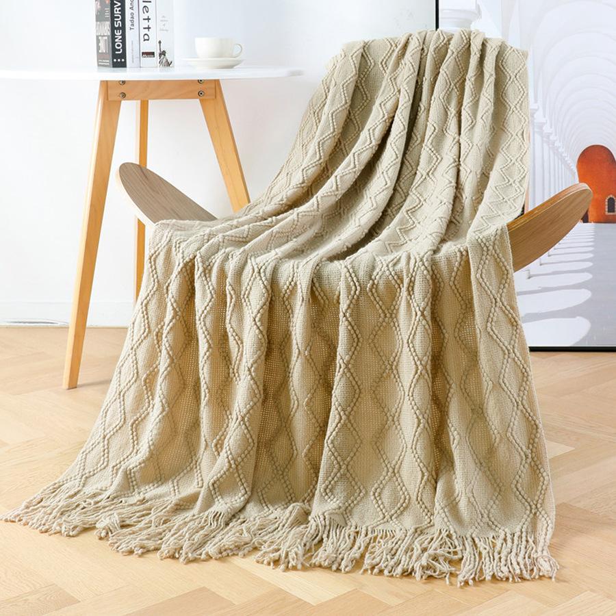 Orange knitted throw blanket for model homes, suitable for use as a sofa or bed throw, for furniture stores and home showrooms as a soft decoration