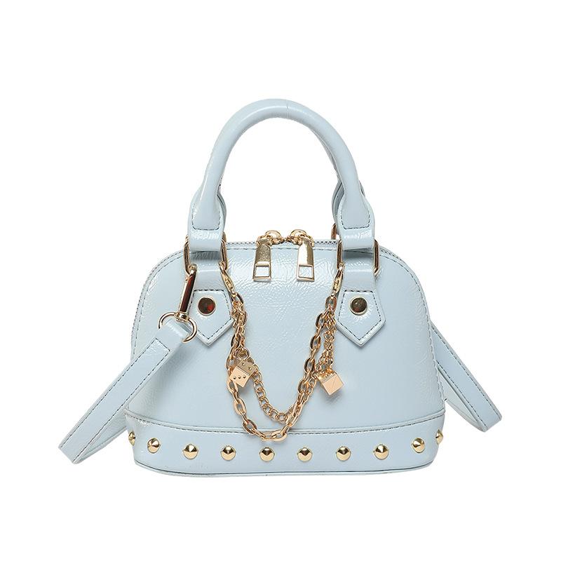 

Women bags women s bags 2025 new Korean version of fashion niche portable personalized rivets messenger shell bag синій
