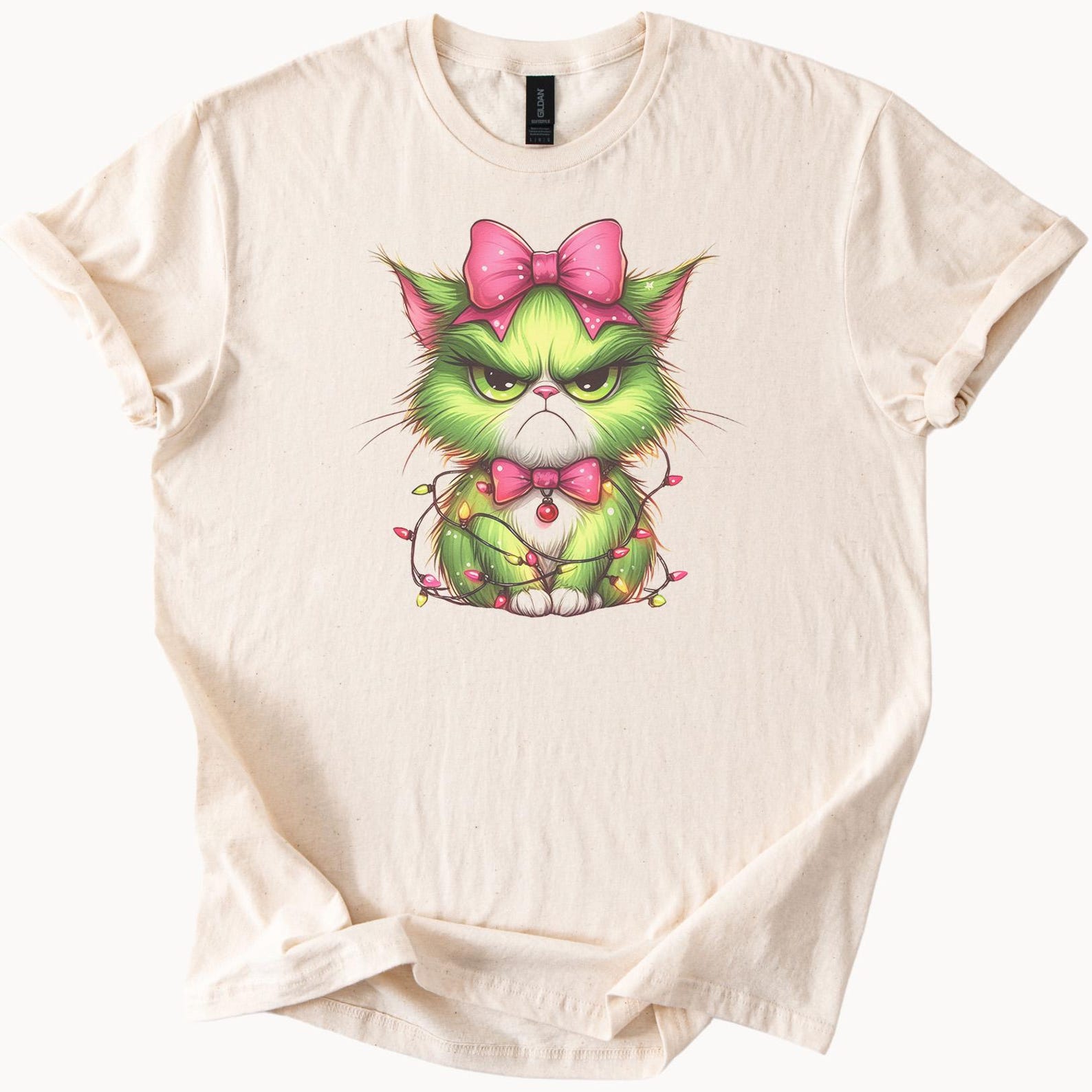 Grumpy Green Cat Shirt Cute Christmas Cat with Pink Bow Light Strands Funny Holiday Kitty Graphic Tee Unique Cat Lover Gift Shirt 100