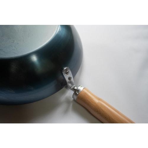 The Little China 24 Iron Frying Pan, a small iron wok that develops with use. Made in Japan, induction compatible, lightweight, no seasoning required,
