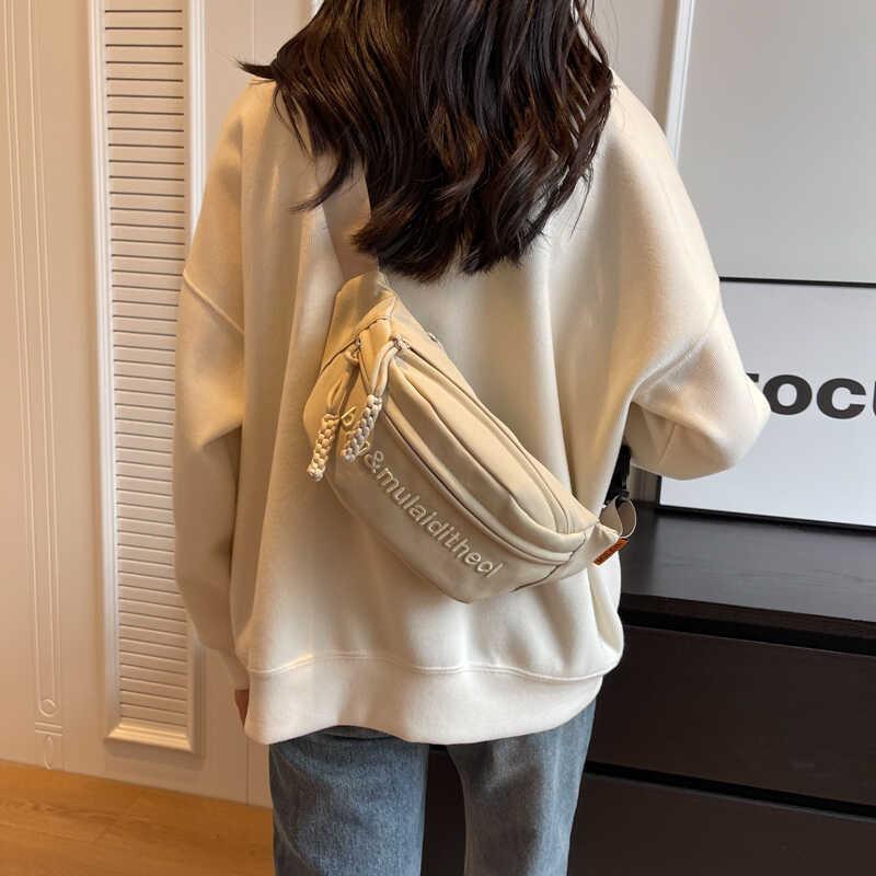 Versatile Water-resistant Canvas Crossbody Bag With Letter Print Perfect For Travel And Casual Use