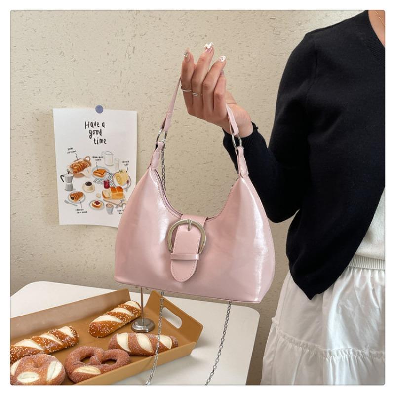 Solid color crescent-shaped hobo bag with metal D-ring embellishment, elegant underarm bag, versatile women's handbag for dates and everyday wear.