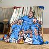 Group of athletes in blue jerseys with bold text and vibrant backdrop. for all seasons blanket lunch break throw gift