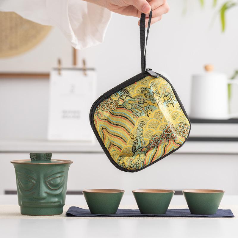 

Sanxingdui imitation bronze mask ceramic travel tea set one pot three cups outdoor portable retro commemorative gift
