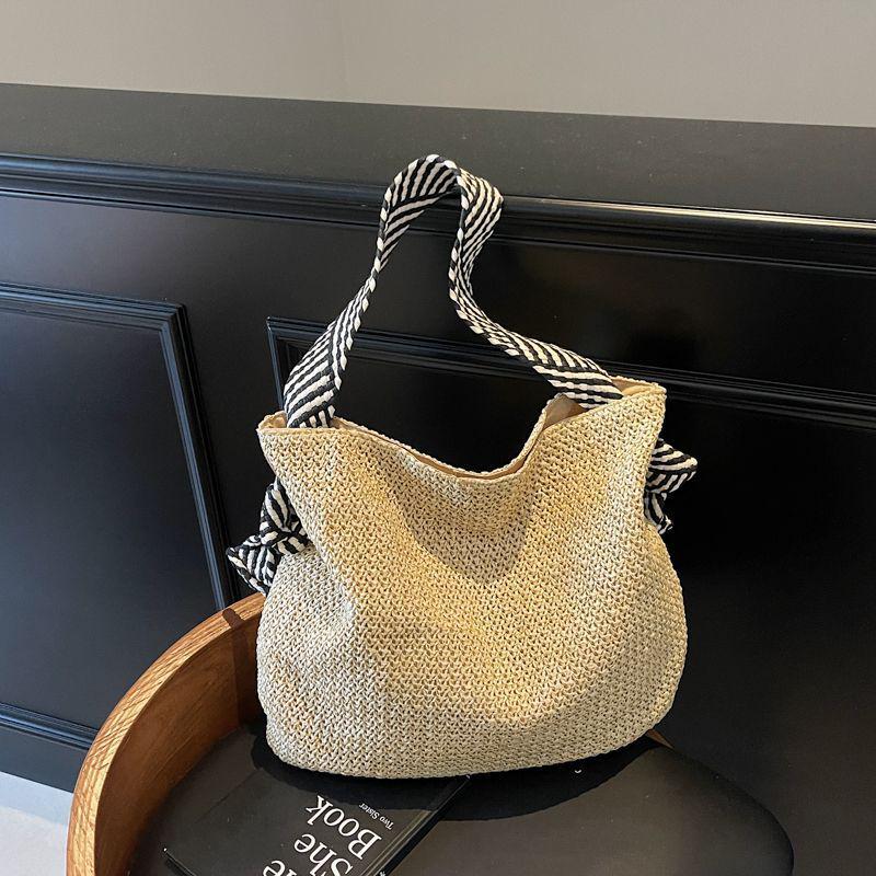 Hollow Straw Woven Tote: Fashionable, Large Capacity Shoulder & Handheld Bag for Seaside Vacation or Commute.