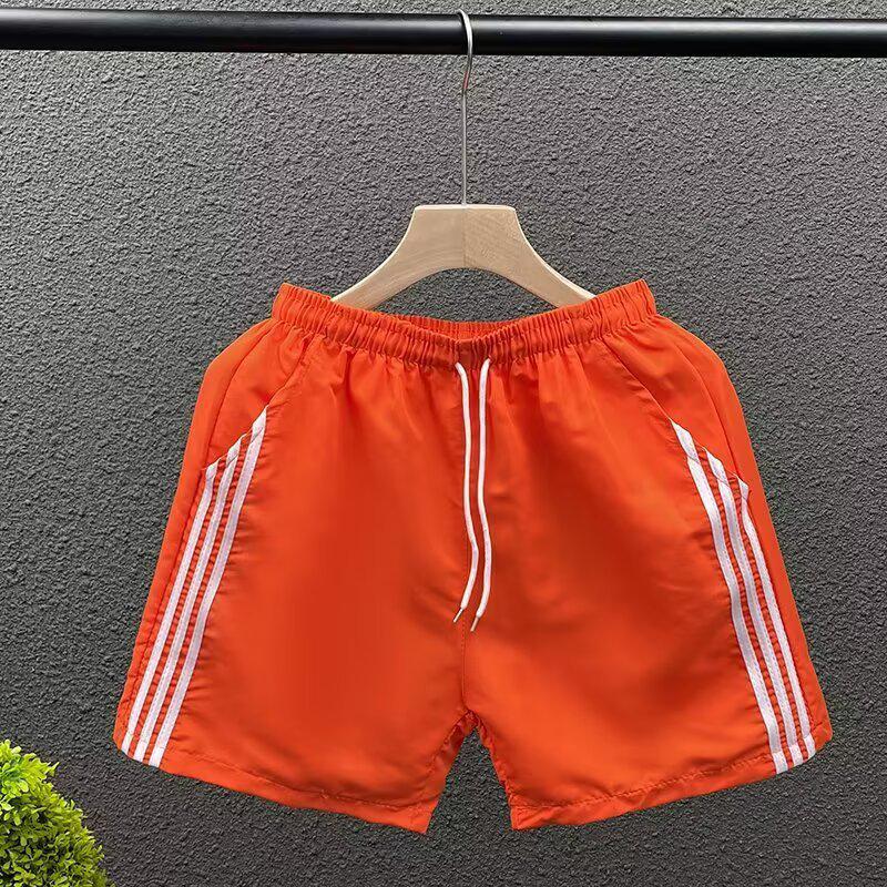 

Летние спортивные шорты средней длины в корейском стиле с тремя полосками - Унисекс, трендовый свободный крой M оранжевый