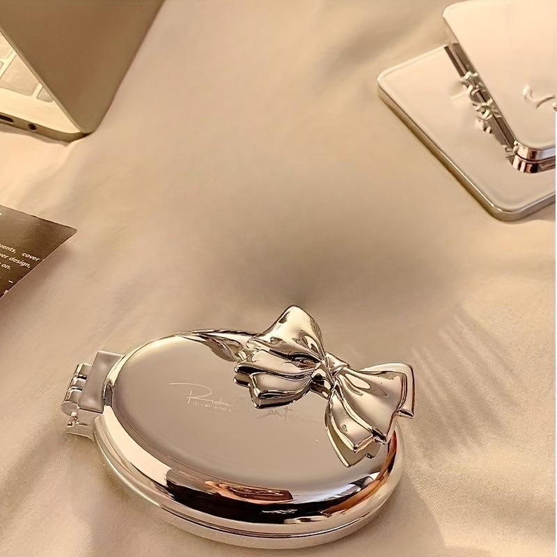 

Portable Mini Bow-Shaped Hair Comb - Nylon Bristles Folding Air Cushion for Normal Hair Travel-Friendly Styling Tool with Mirror серебряный