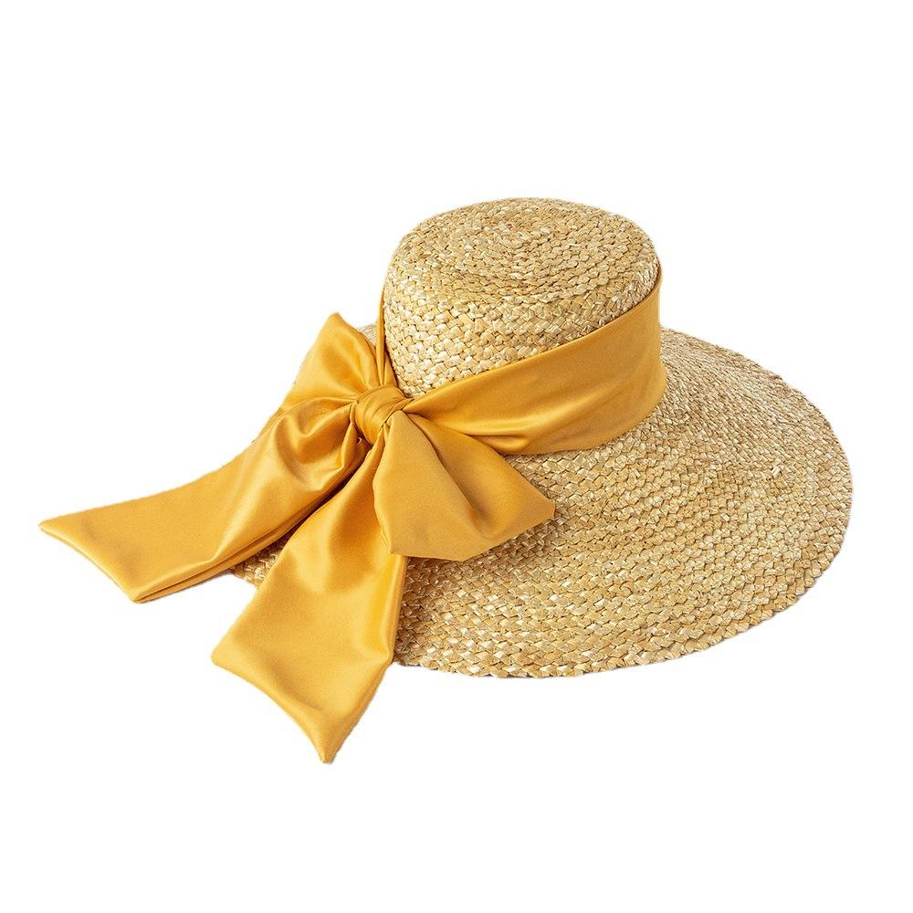 Europäische und amerikanische Mode Retro Schleife handgewebte Blüten Strohgras flache Krone großes Schirmloch Hut Outdoor Strand Sonnenschutz Strohhut