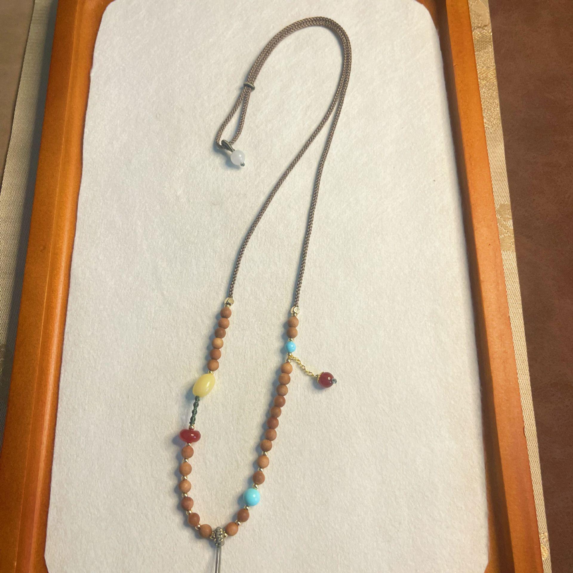 

Luxury Handmade Sandalwood Crystal Jadeite Amber Pendant with Adjustable Hanging Rope