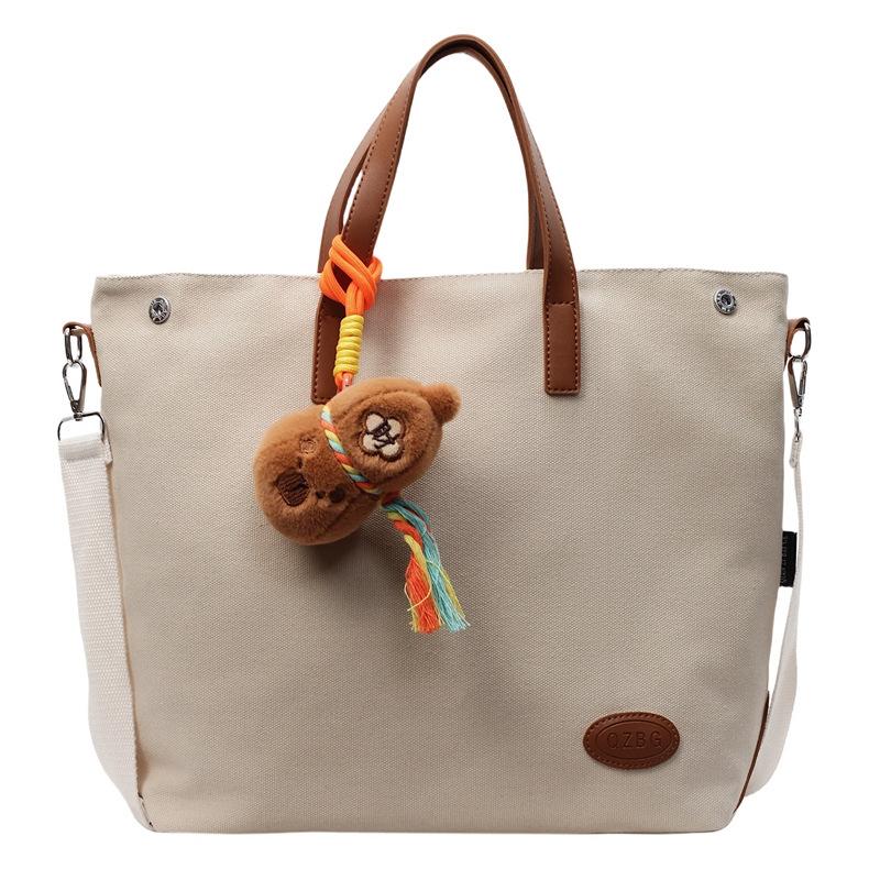 

Cross-border large-capacity handbag women s 2025 new student class simple shoulder bag casual versatile messenger bag single package бежевий