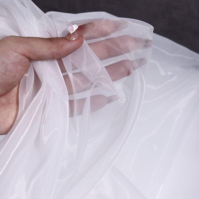 The thickened and encrypted soft light organza fabric can be used for wedding dresses evening gowns and designer clothing fabric
