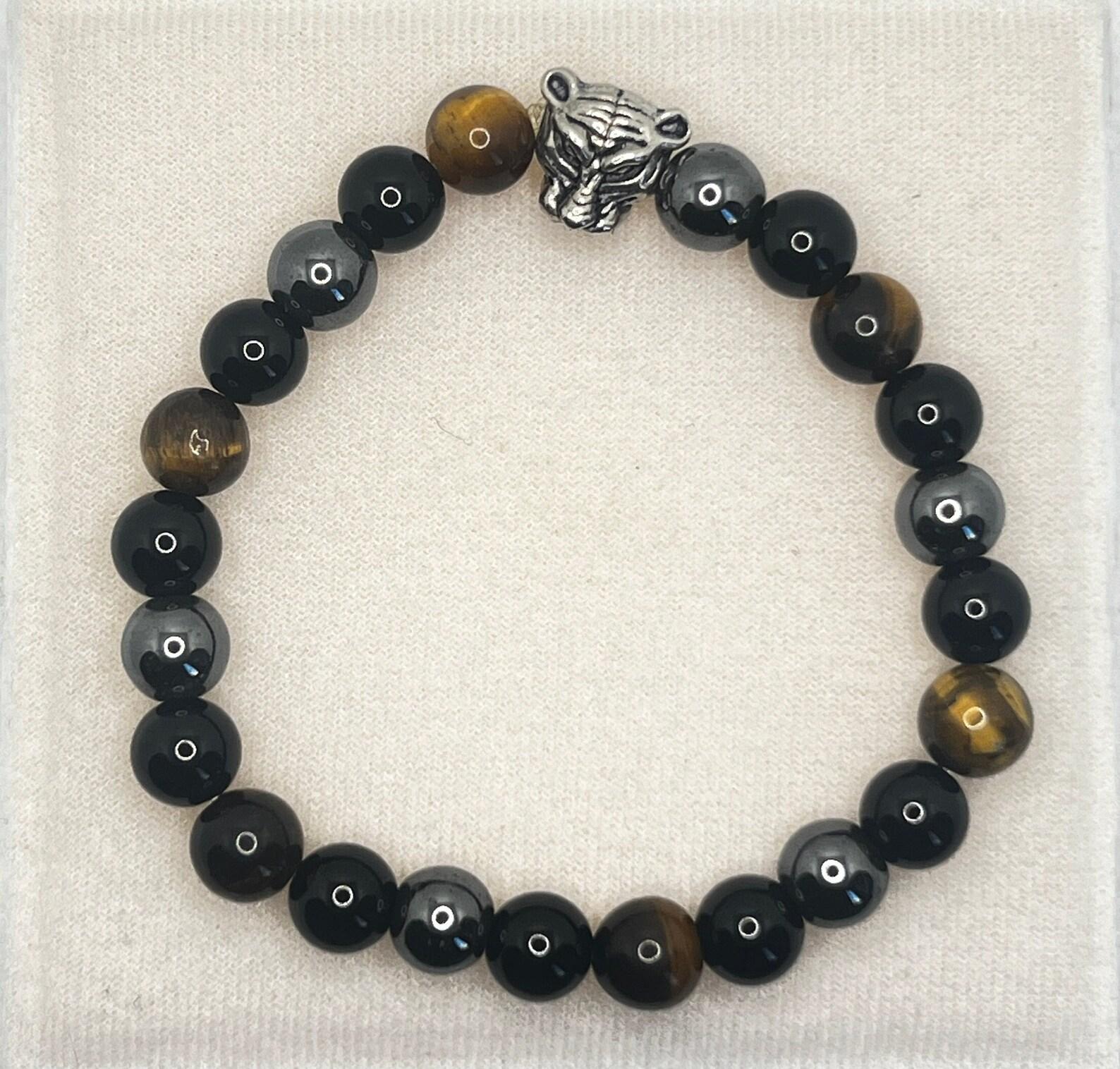 

Triple Protection 8mm Bracelet: Tiger Eye, Black Hematite Beaded Bracelet with Silver Tiger Head Charm | Stylish, Durable, & Meaningful Gift for Him коричневий