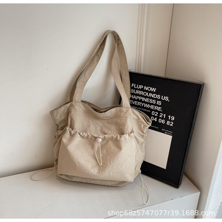 2025 new large-capacity drawstring canvas bag casual Korean version women's solid color daily commuting shoulder tote bag women