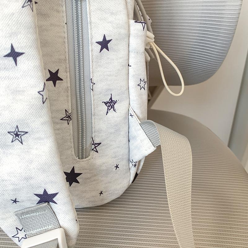 Star-Printed Backpack with Front Zipper Pocket and Tassel Details for School and Daily Use
