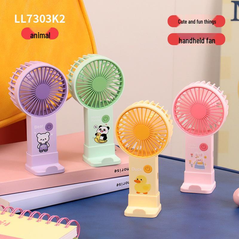 

Cute Cartoon Mini Handheld USB Charging Fan & Portable Phone Holder - Large Wind Power for Office Use Custom/Wholesale/Cross-border