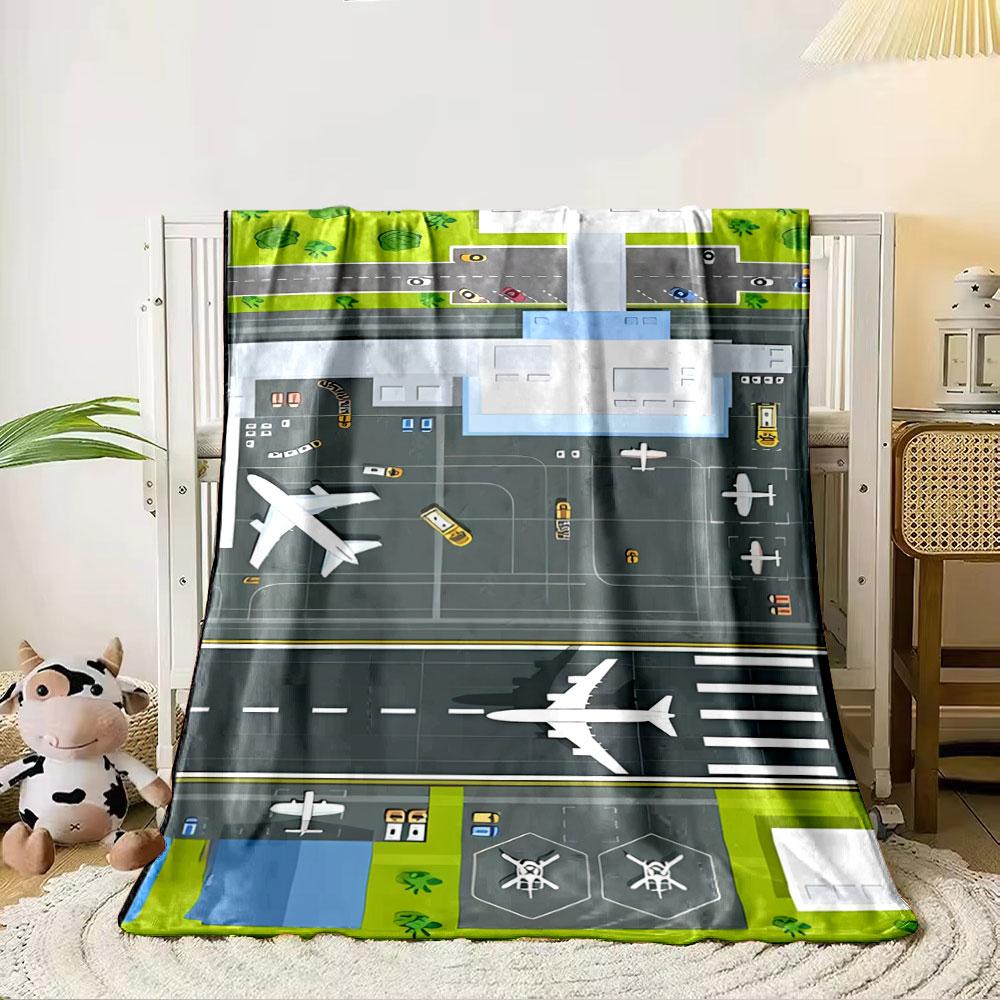 An aerial view of an airport layout with planes, runway, and vehicles. for all seasons blanket lunch break throw gift