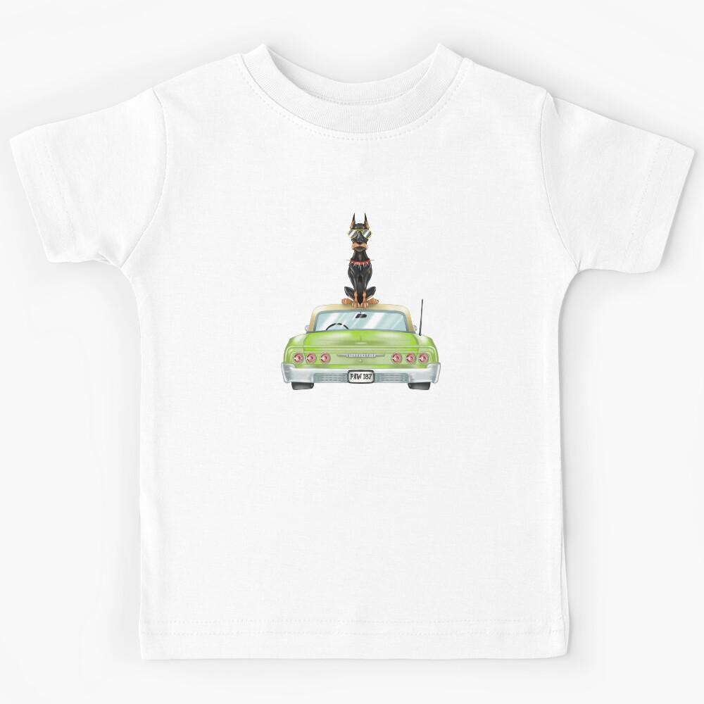 Doberman sitting on a Chevrolet Impala Kids T-Shirt 140