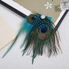 An Artificial Peacock Feather Hair Accessory, Adorned with Rhinestone Floral Clips, for Special Occasions And Stylish Outfits.