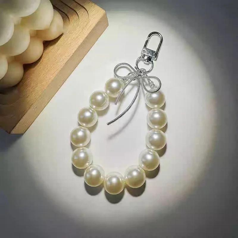 

Advanced feeling electroplated silver pearl mobile phone strap, sweet bow headphone case, bag, car key pendant білий