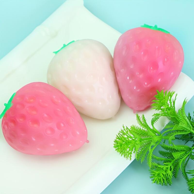 1 Simulated Color Changing Strawberry Toy, A Stress Relief Toy That Changes Color In The Sunlight, and A Decompression Rebound