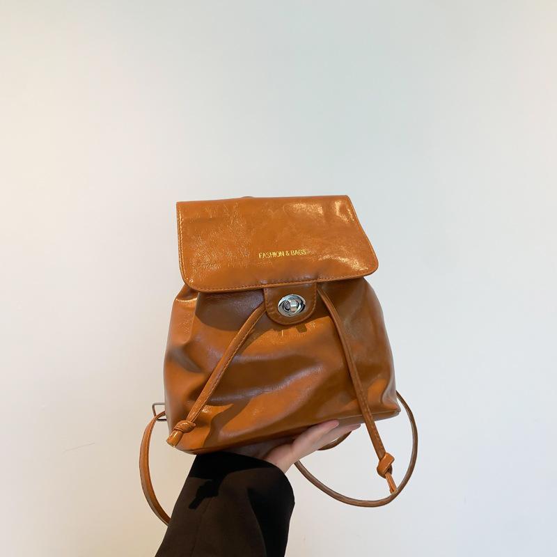 

Корейська версія модної портативної жіночої сумки-відра 2024 року, нової красивої сумки через плече, іноземного повсякденного рюкзака темно-коричневого кольору