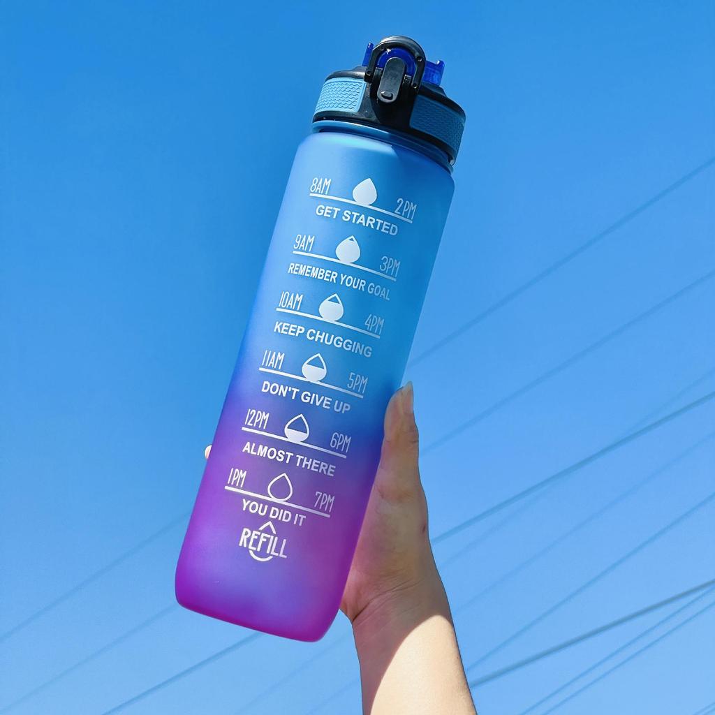 Gradient Large Capacity Sports Water Bottle with Scale, Portable Rope, and Bouncing Straw.