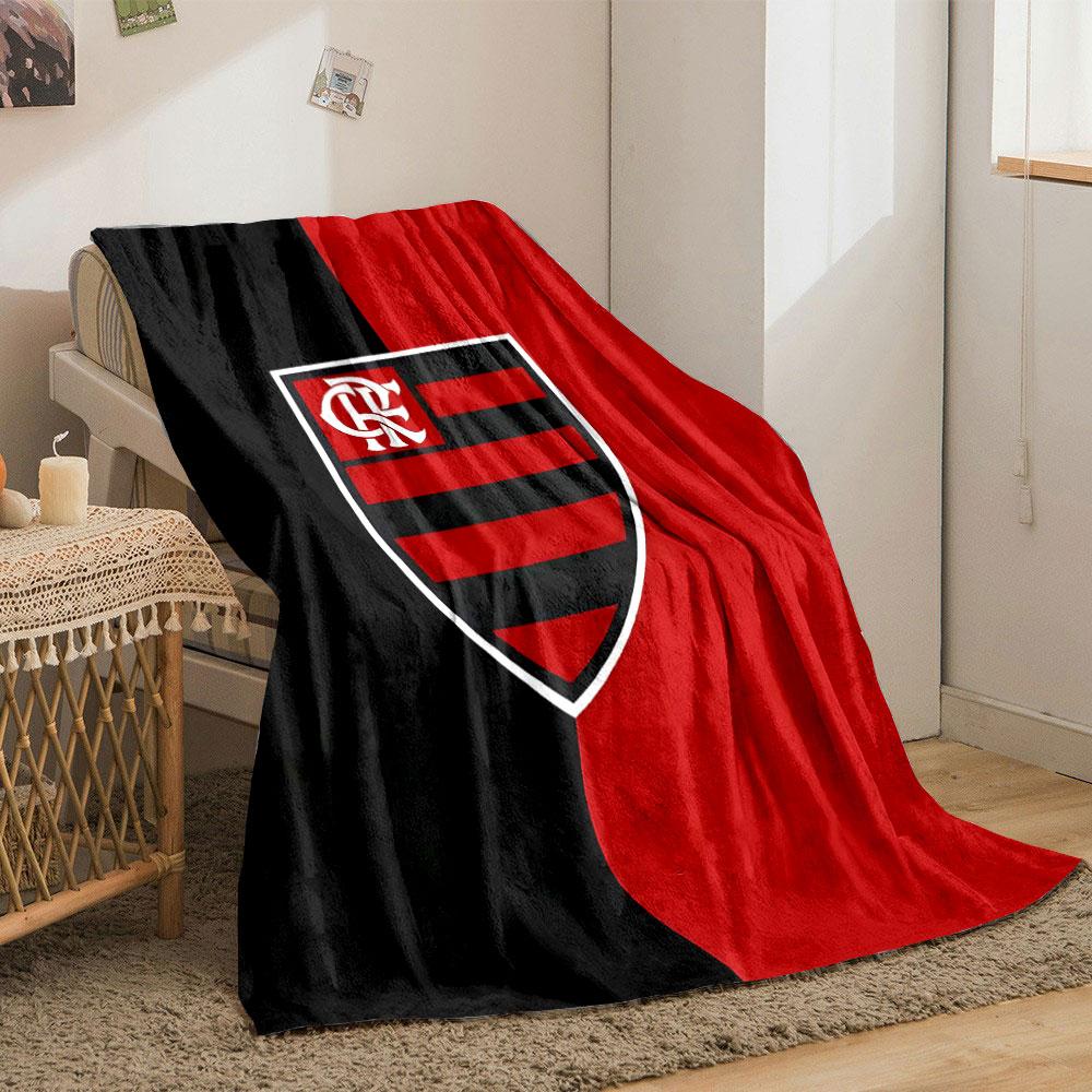 A vertically split black and red background with a striped shield emblem. for all seasons blanket lunch break throw gift
