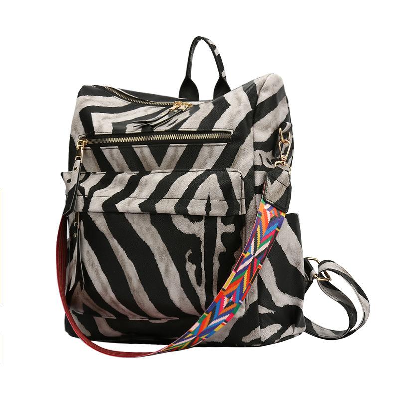 Neuer PU Retro Rucksack mit großer Kapazität für Reisen, Kuhmuster, schlichter britischer Stil, schräg über die Schulter tragbar, für Damen