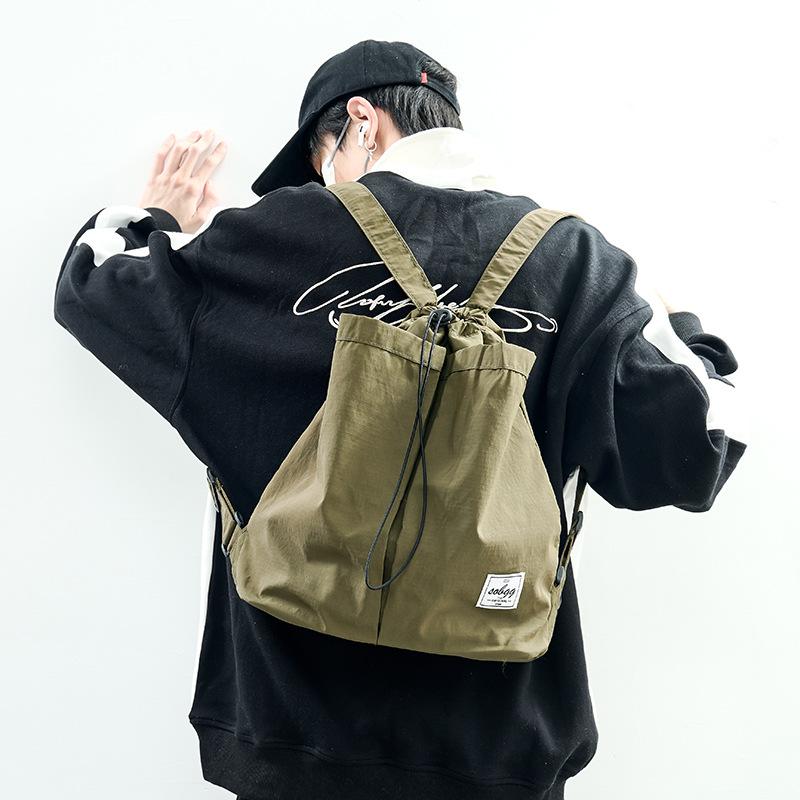 The new Hong Kong wind locomotive drawstring is simple andlarge-capacity leisure. Men and women have the same commuter backpack and student schoolbag.