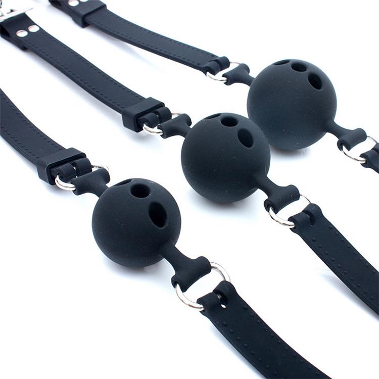 Icele Silicone Oral Sex Gag: Black, Soft Gel Ball with Hole In Various Sizes for Erotic Play.
