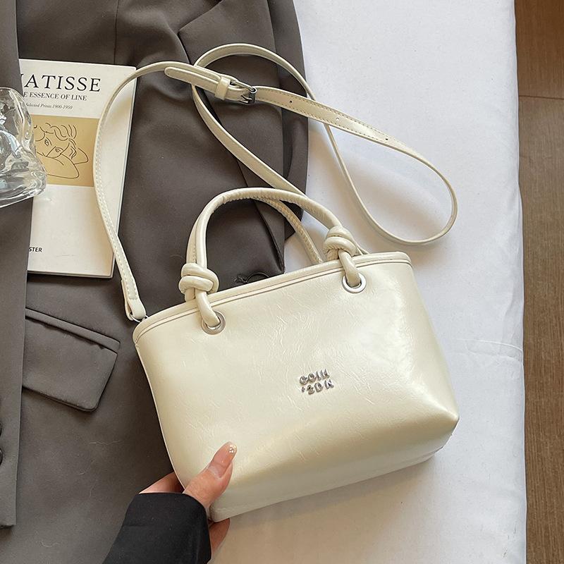 2025 new Korean simple oil wax leather portable bucket bag fashionable versatile solid color foreign style commuter messenger women's bag