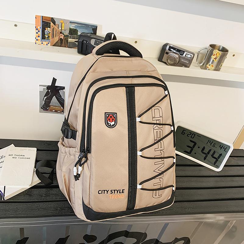 High-value retro tooling trendy and cool backpack for junior high school students, casual, simple, lightweight and large-capacity backpack.