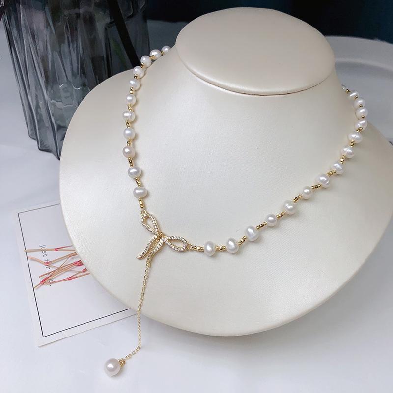 Elegant White Pearl Necklace with Bow Design and Spacer Beads