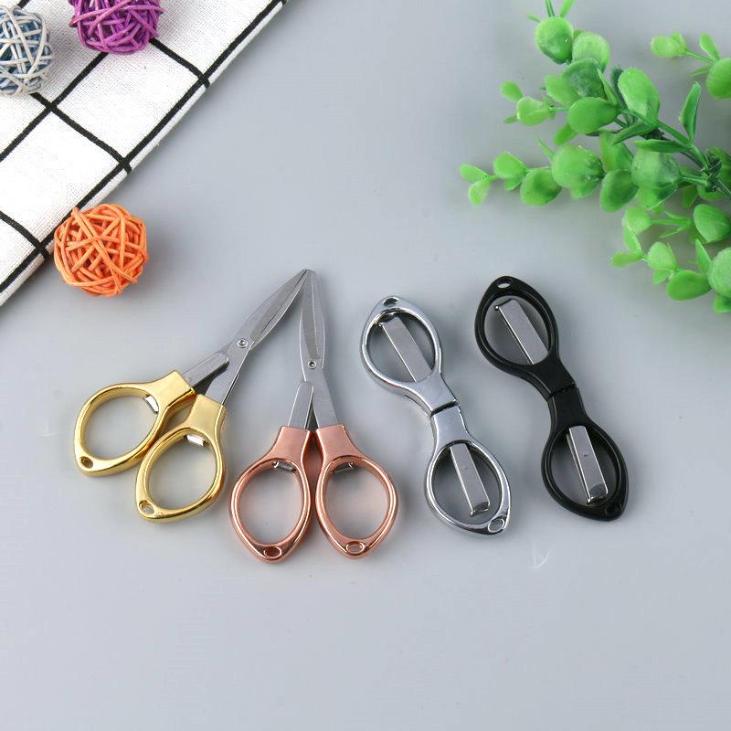Rose Gold 8-Shaped Stainless Steel Folding Travel Scissors - Portable and Compact for Fishing and Eyeglass Needs.