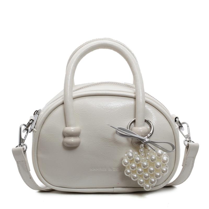 Korean version of the hot-selling cream style portable bowling bag, girls' fashion and advanced sense, foreign style versatile simple messenger bag