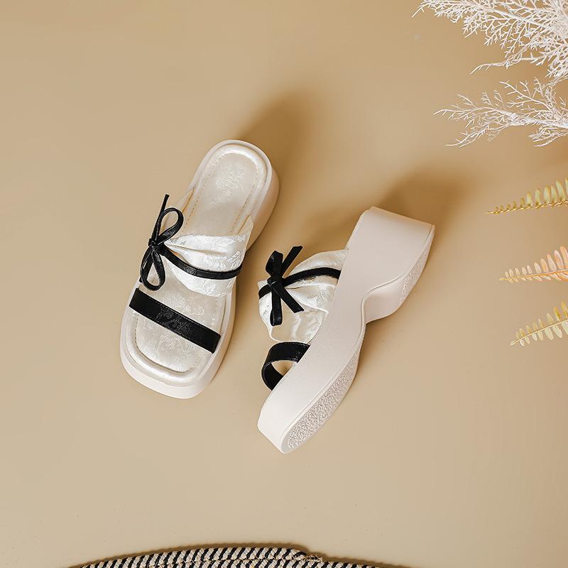 

Thick-soled one-word slippers female summer new fairy middle heel muffin outer wear niche design toe bow sandals 34